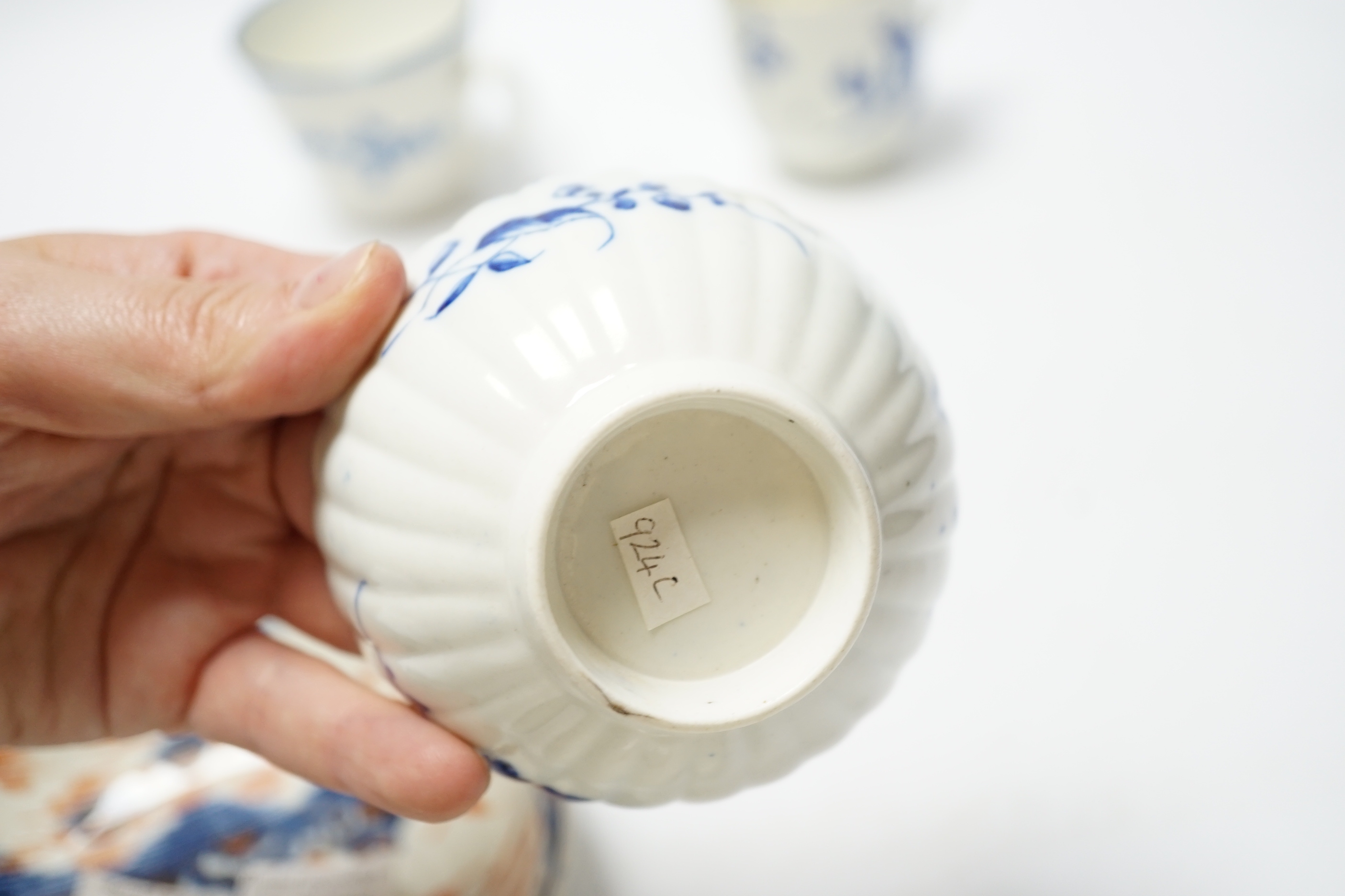 A Worcester James Giles decorated coffee cup, c.1765-70, a Caughley reeded tea bowl, a Pennington tea bowl and saucer and a coffee cup, tallest cup 6.5cm (4)